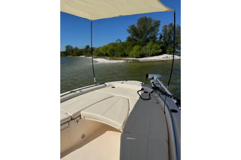 Slide: The Image of 2023 Grady-White 251 Coastal Explorer boat near a scenic shoreline. - 6