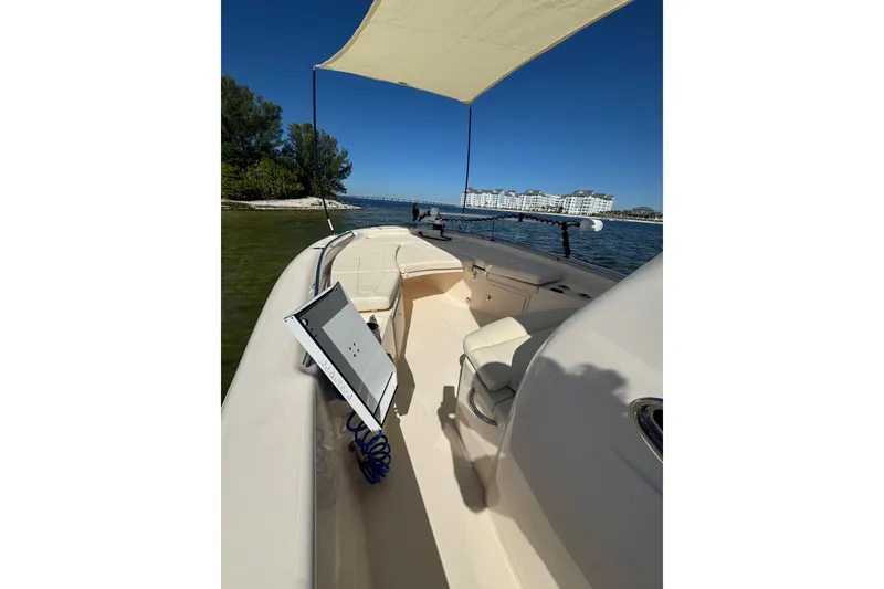 Slide: The Image of 2023 Grady-White 251 Coastal Explorer boat with canopy, on calm waters near shoreline. - 7