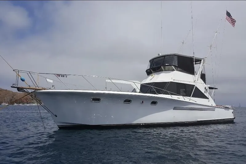 The Image of 1974 Pacemaker 48 Sportfisherman yacht on calm water with American flag. - 0