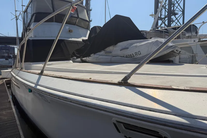 Slide: The Image of 1974 Pacemaker 48 Sportfisherman yacht docked, showcasing deck and cabin details. - 10