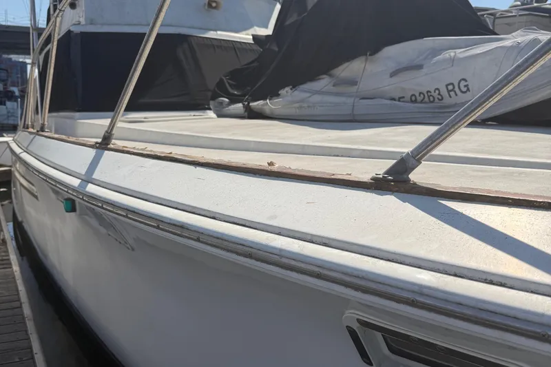 Slide: The Image of 1974 Pacemaker 48 Sportfisherman boat docked, showing deck and railing details. - 11