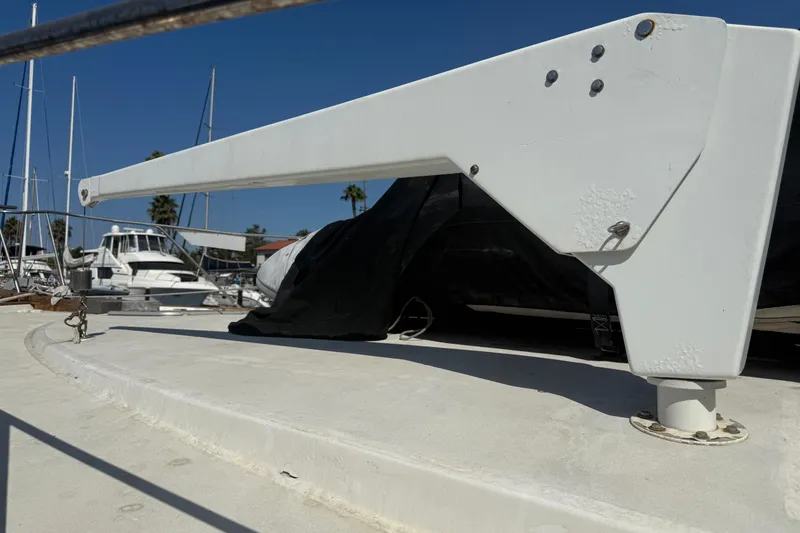 Slide: The Image of 1974 Pacemaker 48 Sportfisherman yacht deck with davit, marina background. - 12