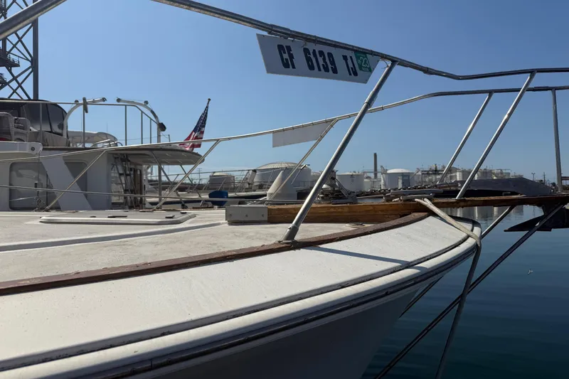 Slide: The Image of 1974 Pacemaker 48 Sportfisherman boat docked, featuring deck and railing details. - 16