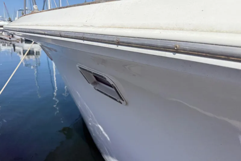 Slide: The Image of 1974 Pacemaker 48 Sportfisherman boat docked, side view with water reflection. - 17