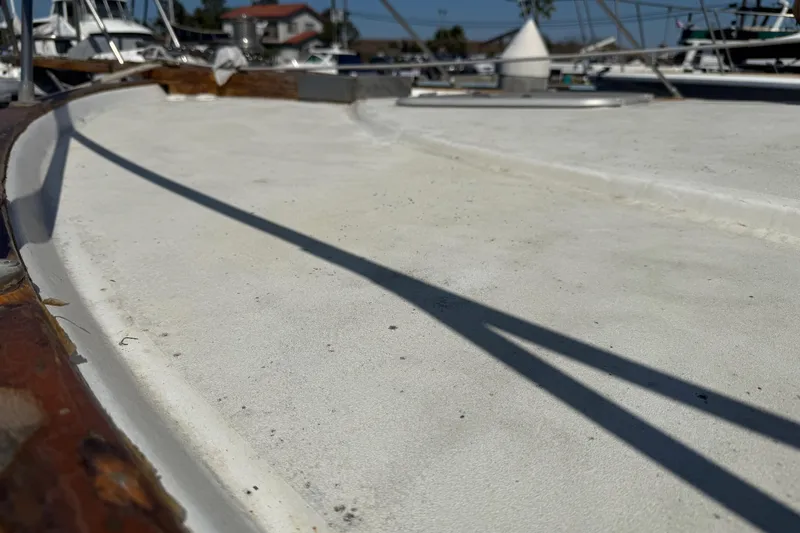 Slide: The Image of 1974 Pacemaker 48 Sportfisherman boat deck with shadows and marina background. - 18