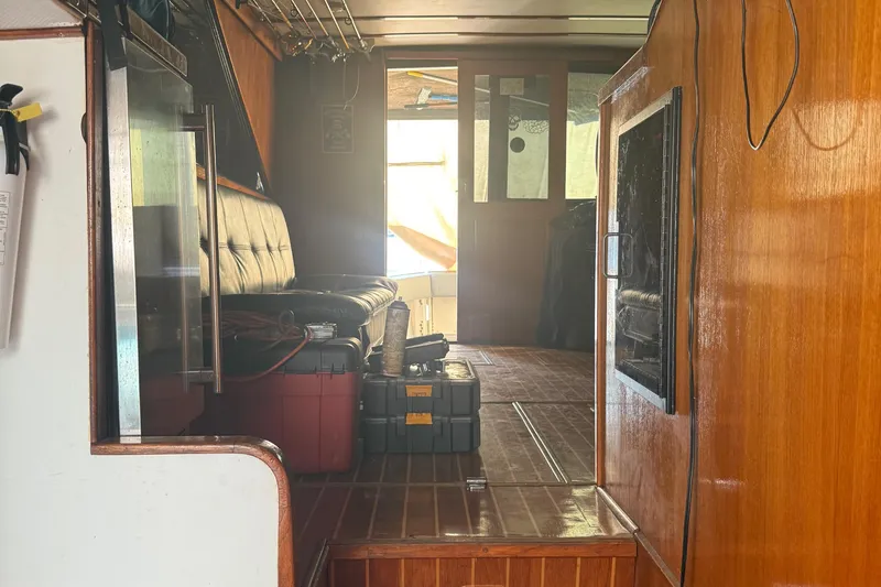 Slide: The Image of Interior of a 1974 Pacemaker 48 Sportfisherman boat with wooden paneling and seating. - 24