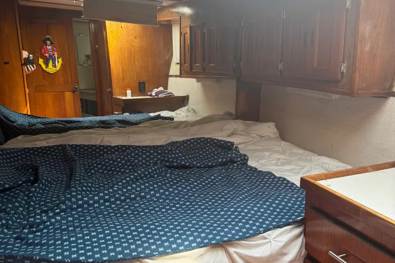 Slide: The Image of Interior cabin of a 1974 Pacemaker 48 Sportfisherman with wooden cabinetry and bed. - 25