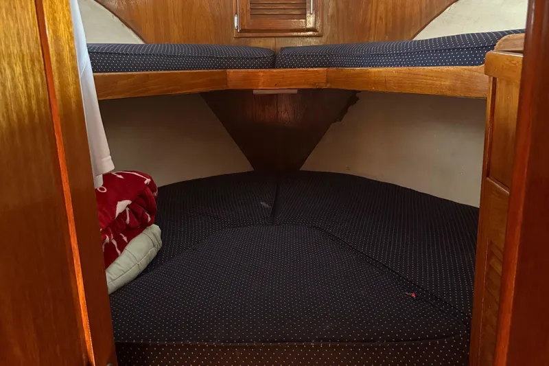 Slide: The Image of Cozy cabin interior of 1974 Pacemaker 48 Sportfisherman with cushioned seating and wooden accents. - 26