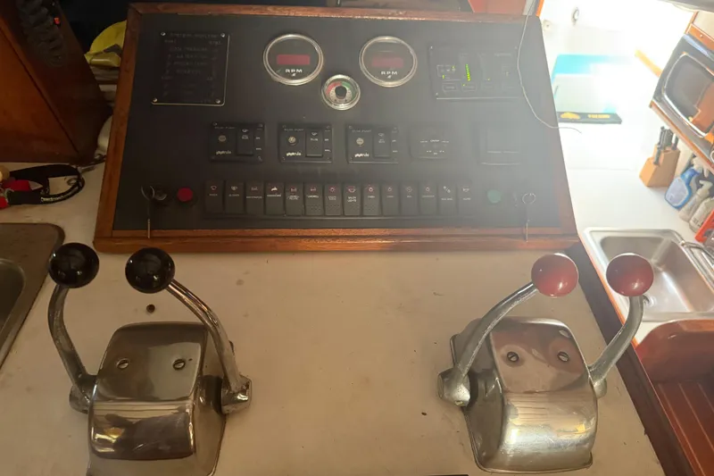 Slide: The Image of Control panel of a 1974 Pacemaker 48 Sportfisherman boat with levers and gauges. - 29