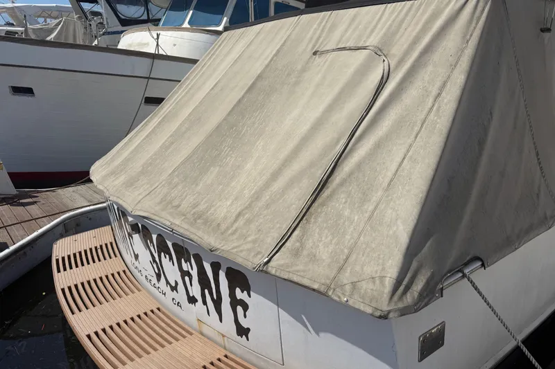 Slide: The Image of 1974 Pacemaker 48 Sportfisherman boat docked with canvas cover, Long Beach, CA. - 3