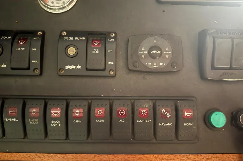 Slide: The Image of Control panel of a 1974 Pacemaker 48 Sportfisherman boat with various switches and gauges. - 31