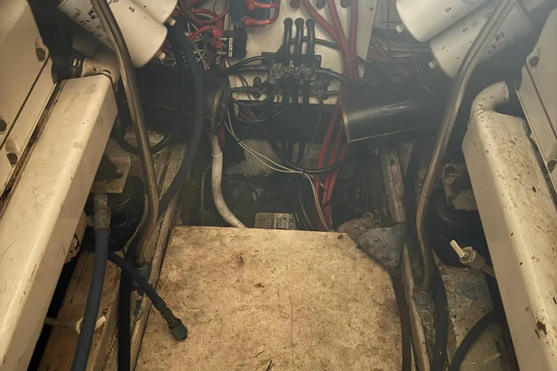 Slide: The Image of Engine room of a 1974 Pacemaker 48 Sportfisherman, showing mechanical components and wiring. - 36