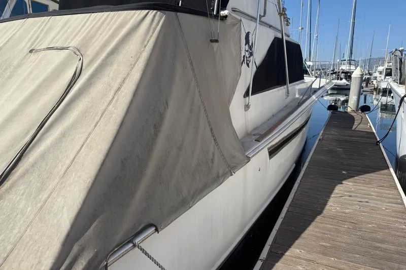 Slide: The Image of 1974 Pacemaker 48 Sportfisherman yacht docked at marina, side view with canvas cover. - 4