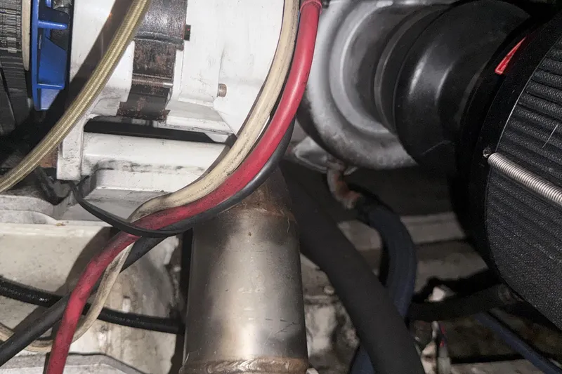 Slide: The Image of Engine components of a 1974 Pacemaker 48 Sportfisherman, featuring wires and metal parts. - 43