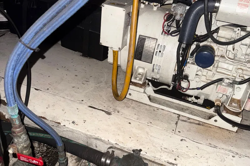 Slide: The Image of Engine room of a 1974 Pacemaker 48 Sportfisherman with visible wiring and hoses. - 46