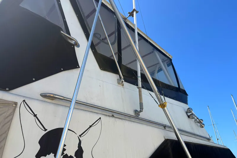 Slide: The Image of 1974 Pacemaker 48 Sportfisherman boat exterior with fishing rods and clear blue sky. - 5