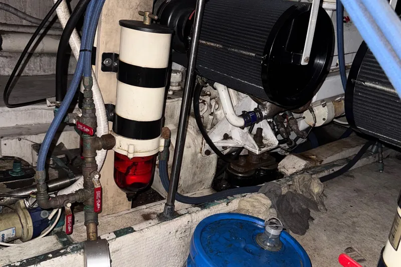 Slide: The Image of Engine compartment of a 1974 Pacemaker 48 Sportfisherman with visible components and hoses. - 50