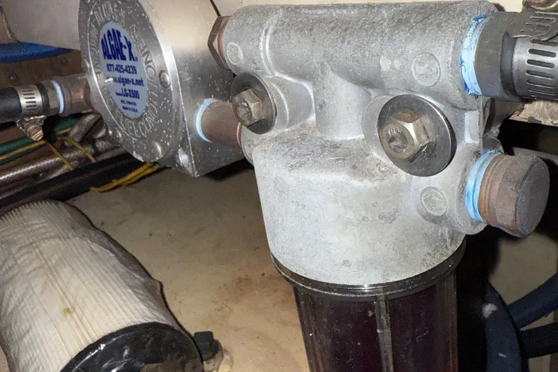 Slide: The Image of Engine component of a 1974 Pacemaker 48 Sportfisherman boat, featuring a fuel filter system. - 51