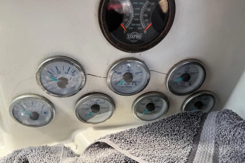 Slide: The Image of Dashboard gauges of a 1974 Pacemaker 48 Sportfisherman boat, featuring voltmeter and oil pressure indicators. - 53