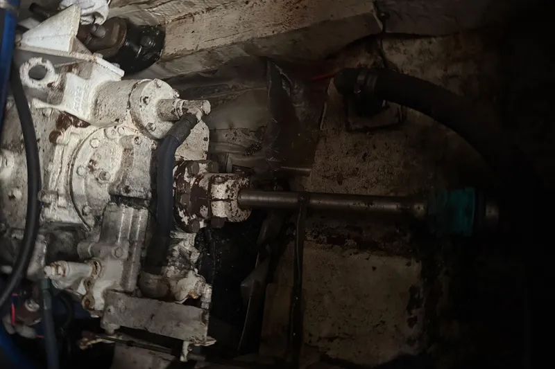 Slide: The Image of Engine compartment of a 1974 Pacemaker 48 Sportfisherman, showing mechanical components and hoses. - 54