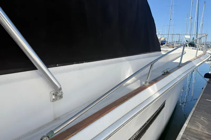 Slide: The Image of 1974 Pacemaker 48 Sportfisherman yacht side view with railing and dock. - 7