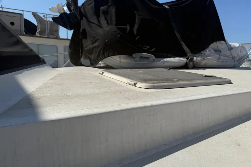 Slide: The Image of 1974 Pacemaker 48 Sportfisherman deck with covered equipment and hatch. - 8