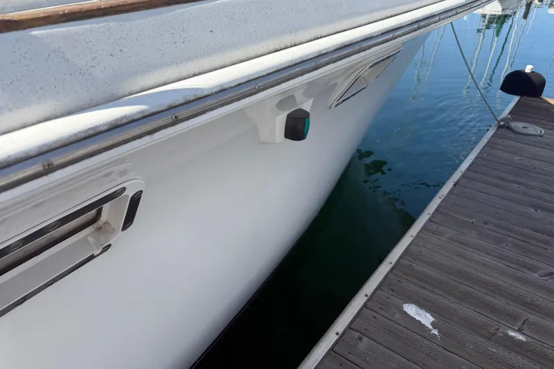Slide: The Image of 1974 Pacemaker 48 Sportfisherman docked, showcasing sleek white hull and marina setting. - 9