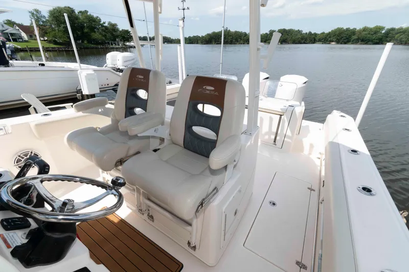 Slide: The Image of 2020 Cobia 320 Center Console boat interior with dual helm seats and modern dashboard. - 13