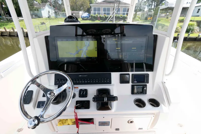 Slide: The Image of 2020 Cobia 320 Center Console helm with advanced navigation display and controls. - 15
