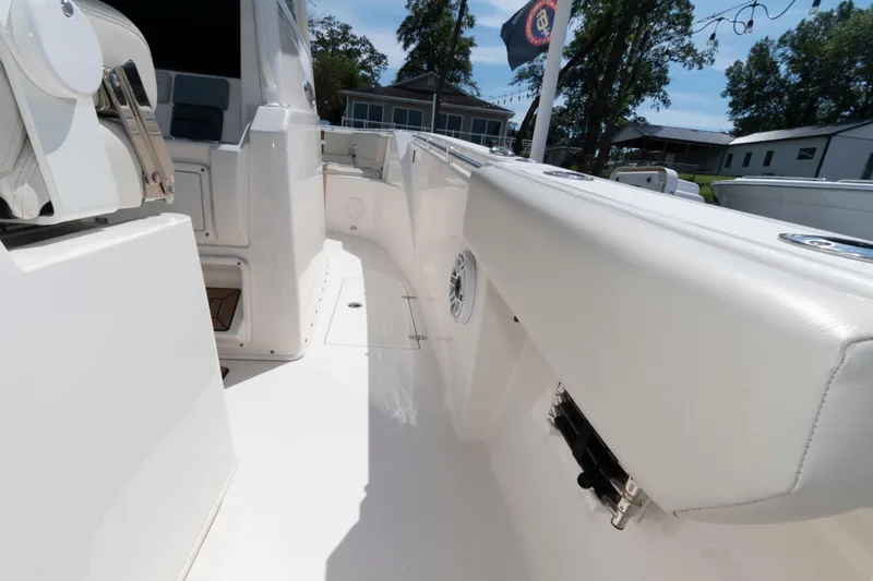 Slide: The Image of 2020 Cobia 320 Center Console boat with open storage compartment and seating. - 19