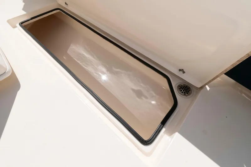 Slide: The Image of 2020 Cobia 320 Center Console boat interior with toilet and sink. - 26
