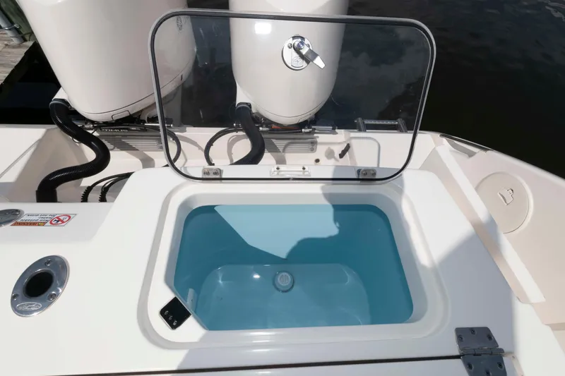 Slide: The Image of Open hatch on 2020 Cobia 320 Center Console boat, revealing storage compartment. - 30
