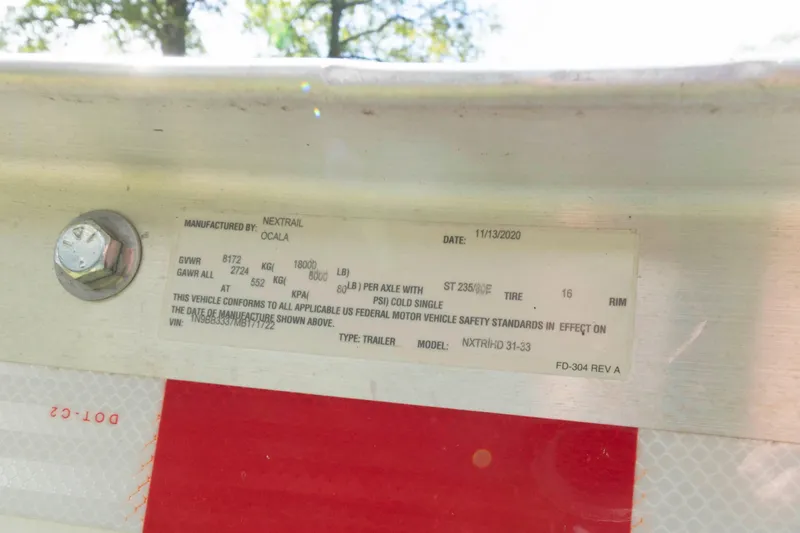 Slide: The Image of Label on a 2020 Cobia 320 Center Console boat trailer, manufactured by Nextrail. - 35