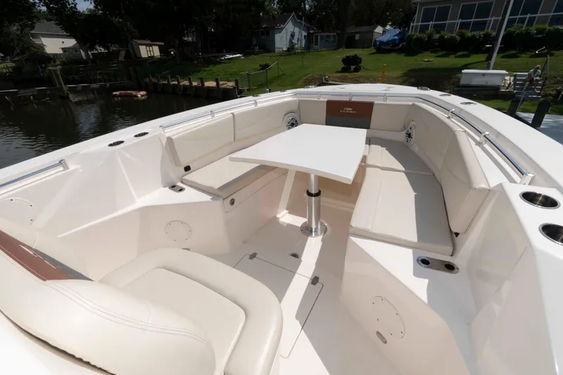 Slide: The Image of 2020 Cobia 320 Center Console boat covered at dock with flags. - 9
