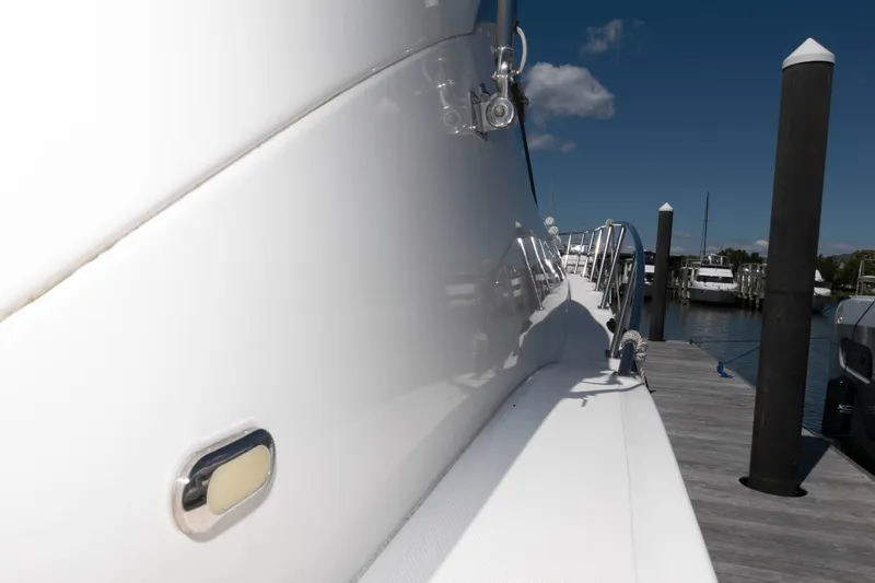 Slide: The Image of 2007 Cruisers Yachts 520 Express docked at marina, side view with clear sky. - 10