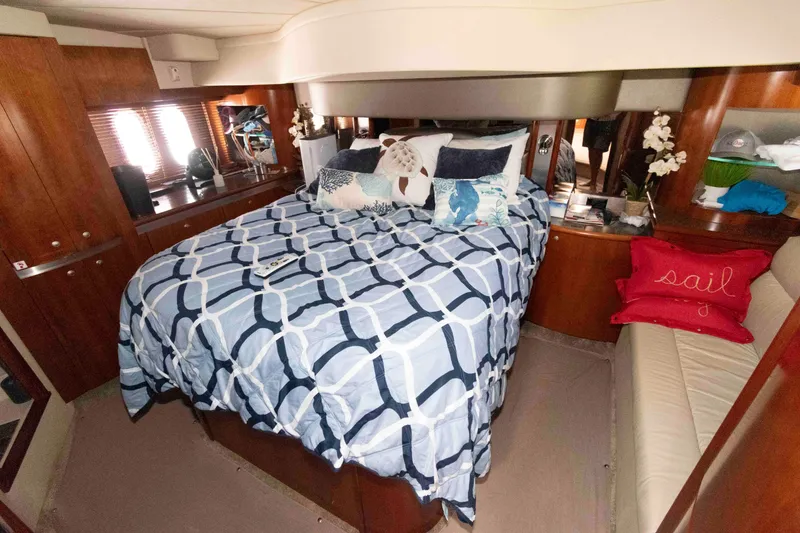 Slide: The Image of Luxurious 2007 Cruisers Yachts 520 Express bedroom with cozy bedding and elegant decor. - 14