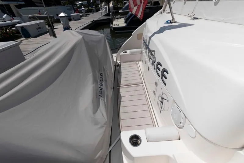 Slide: The Image of 2007 Cruisers Yachts 520 Express docked, featuring covered equipment and sleek design. - 9