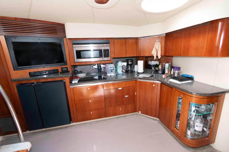 Slide: The Image of Luxurious 2007 Cruisers Yachts 520 Express kitchen with modern appliances and wood cabinetry. - 13