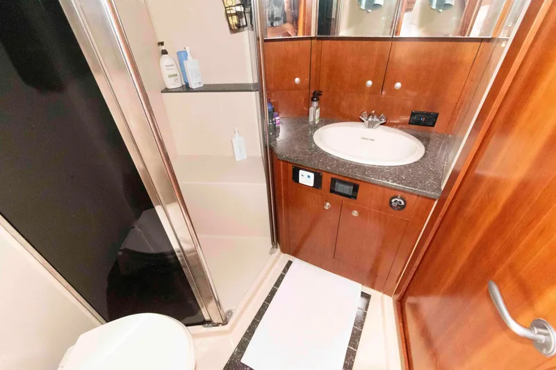 Slide: The Image of Luxurious bathroom in 2007 Cruisers Yachts 520 Express with wood cabinetry and modern fixtures. - 18