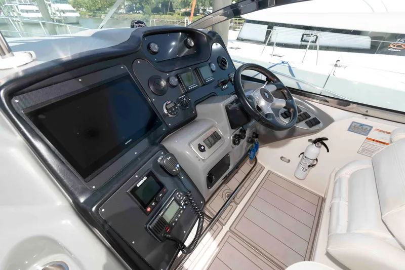 Slide: The Image of 2007 Cruisers Yachts 520 Express helm with modern navigation equipment and luxurious seating. - 6