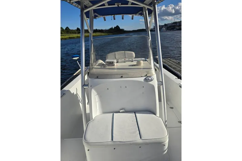 Slide: The Image of 2004 Polar 23 CC boat with seating, docked on a sunny day. - 12