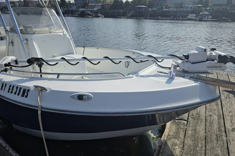 Slide: The Image of 2004 Polar 23 CC boat docked, featuring Garmin equipment, with waterfront view. - 3