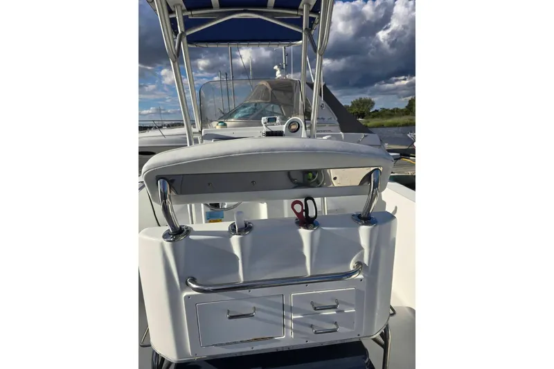 Slide: The Image of 2004 Polar 23 CC boat interior with storage compartments and seating. - 7