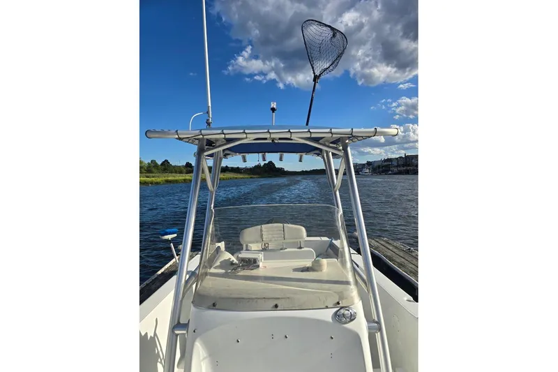 Slide: The Image of 2004 Polar 23 CC boat on water, clear sky, fishing net on T-top. - 8