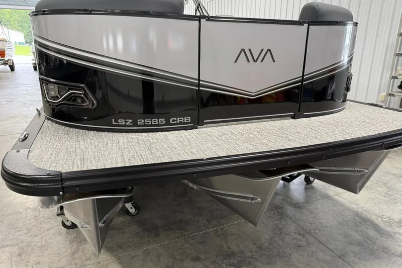 Slide: The Image of 2025 Avalon LSZ Cruise Rear Bench pontoon boat in a showroom setting. - 3