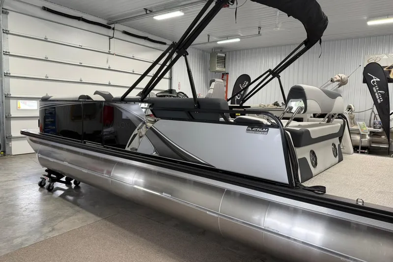 Slide: The Image of 2025 Avalon LSZ Cruise Rear Bench pontoon boat in showroom, featuring sleek design and modern seating. - 5