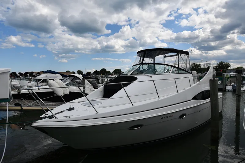 Slide: The Image of 2001 Carver 350 Mariner yacht docked at marina under cloudy sky. - 1