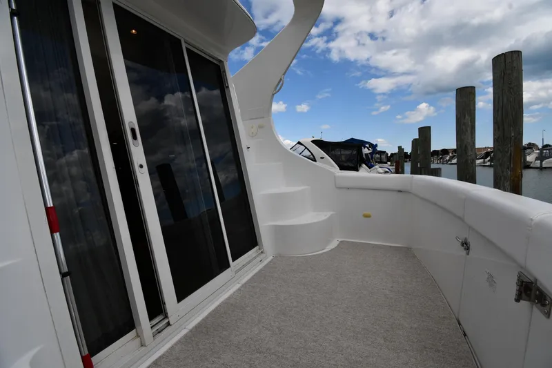 Slide: The Image of 2001 Carver 350 Mariner yacht deck with sliding glass doors and marina view. - 10