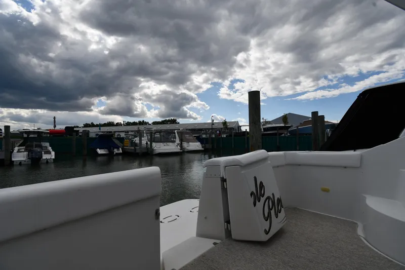 Slide: The Image of 2001 Carver 350 Mariner docked under dramatic cloudy sky at marina. - 12