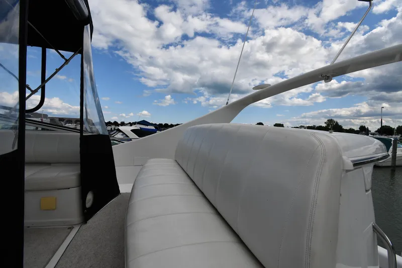 Slide: The Image of 2001 Carver 350 Mariner yacht with white seating, docked under a partly cloudy sky. - 16